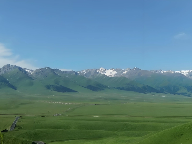 Xinjiang landscape view with mountains, desert, and oasis