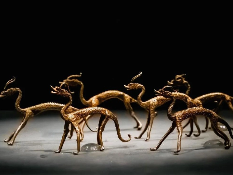 A Tang Dynasty gold bowl with mandarin duck and lotus petal patterns, its exquisite craftsmanship reflecting the cosmopolitan grandeur and luxurious life of the empire.