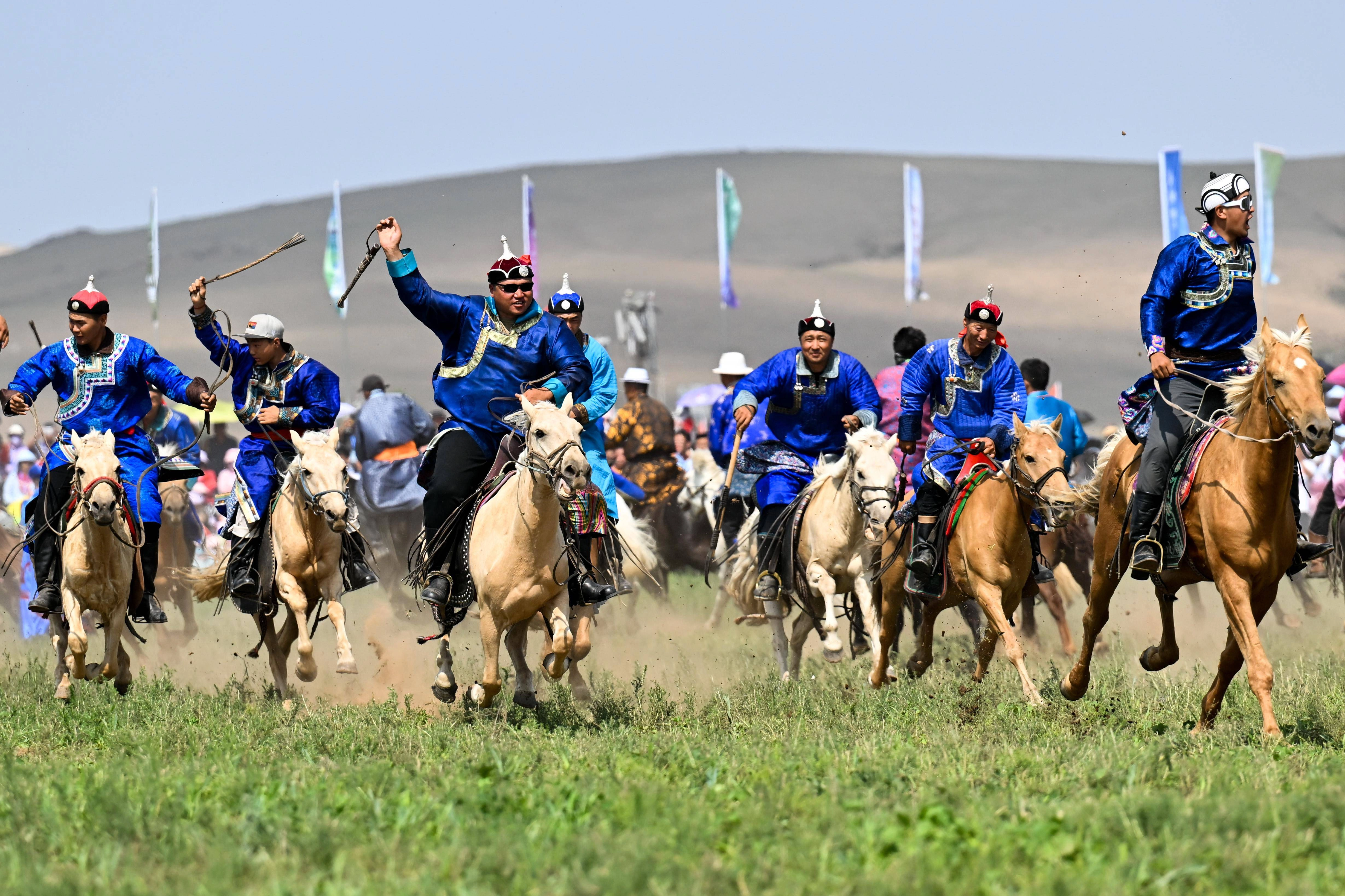Traditional Nadam Festival with horse racing, wrestling and archery competitions on summer grassland