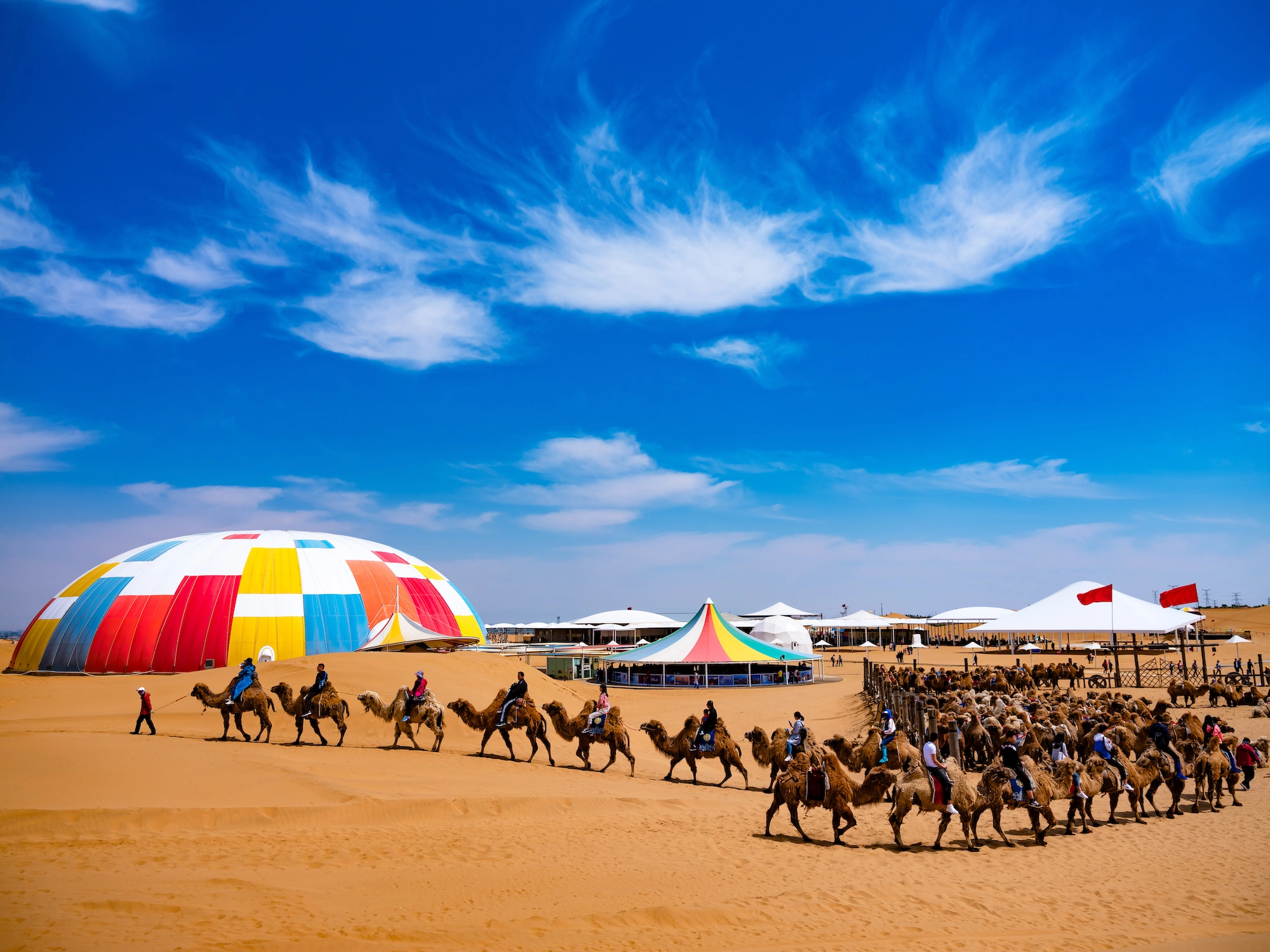 Singing sand dunes of Xiangshawan with unique lotus-shaped hotel in background