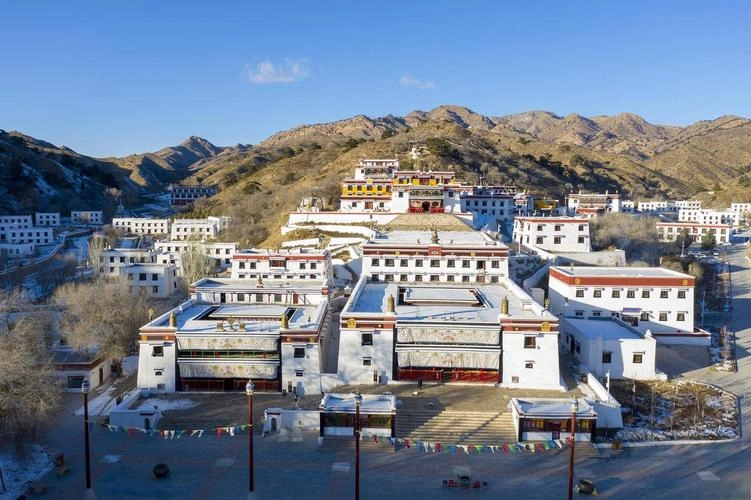 Wudang Lamasery Tibetan Buddhist monastery on grassland mountainside