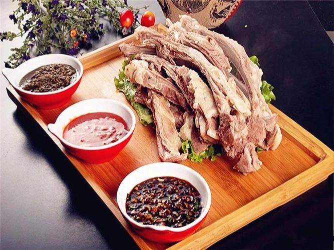 Traditional Mongolian hand-grasped mutton served with broth and dipping sauces