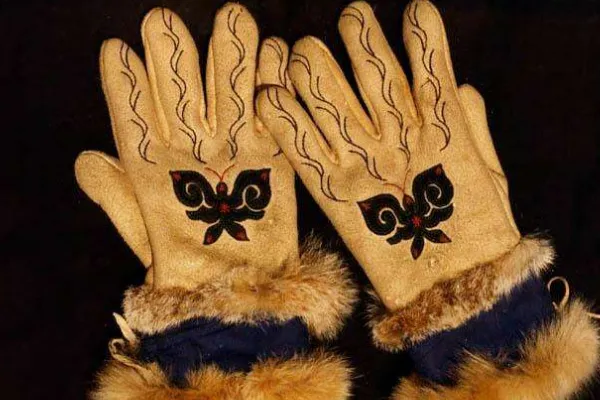 Ewenki artisan crafting roe deer skin products with traditional tools and techniques