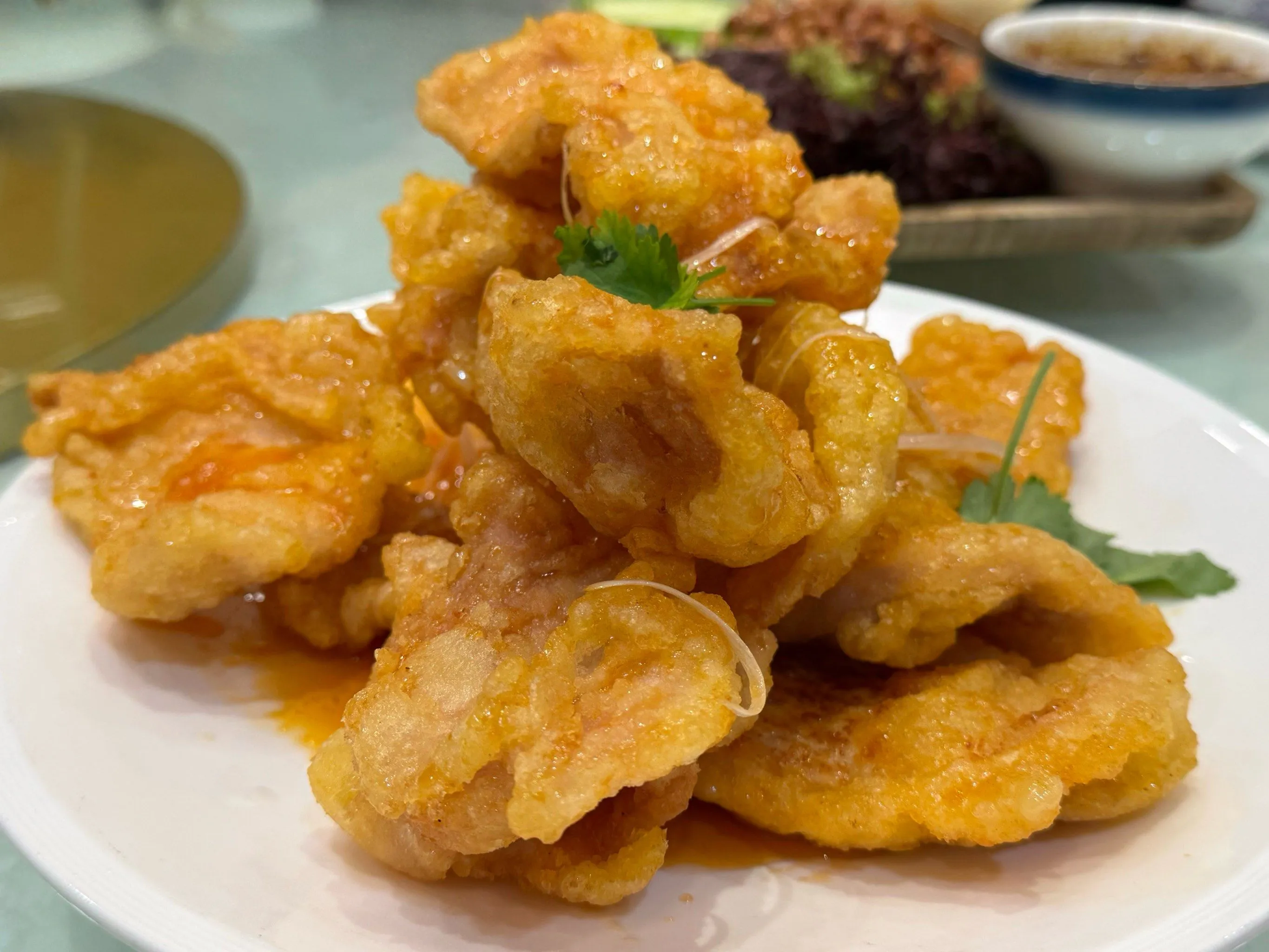 Golden crispy Guo Bao Rou served on plate with sweet and sour sauce