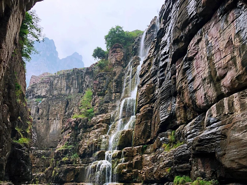 Yuntai Mountain landscape with red cliffs and emerald waterfalls