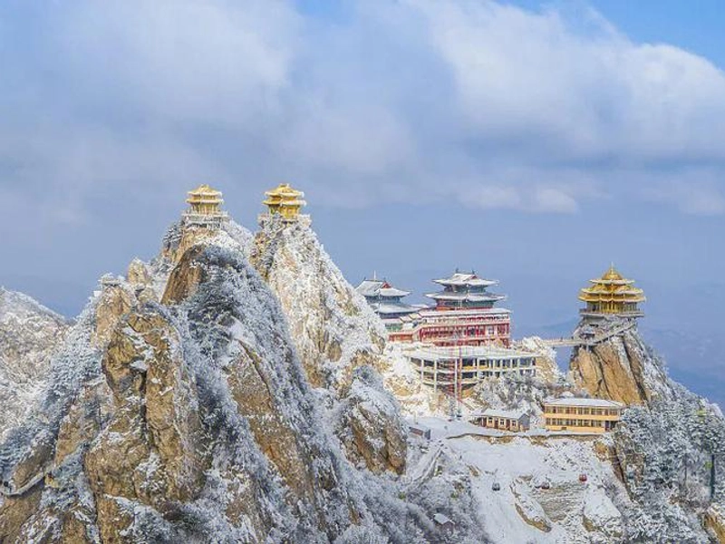 Mount Laojun golden temple amidst clouds and mountain scenery