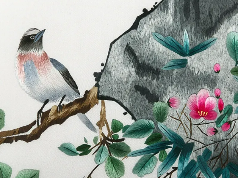 Bian embroidery artisan working on intricate silk embroidery with traditional patterns