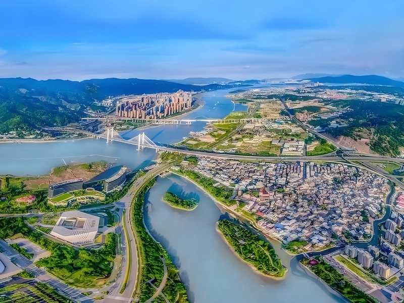 Panoramic view of Fujian's coastal landscape with mountains meeting the sea