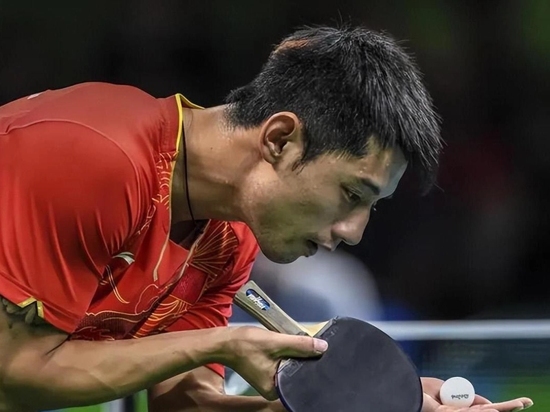 Zhang Jike celebrating with iconic shirt-ripping moment