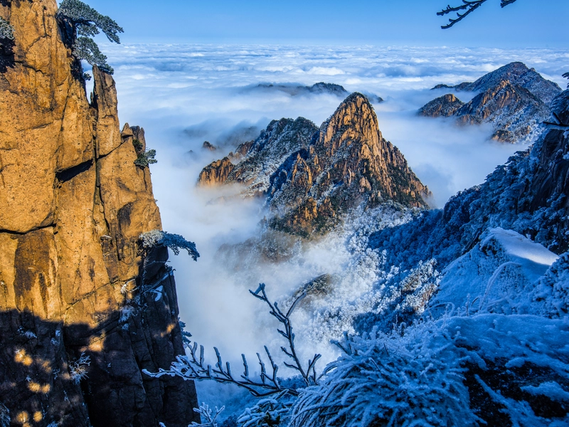 A panoramic view of Anhui Province showcasing Huangshan’s towering peaks, seas of clouds, and ancient Huizhou villages; highlighting rivers, mountains, historic sites, traditional crafts, local cuisine, and cultural heritage that represent Anhui’s unique blend of natural beauty and human achievement.