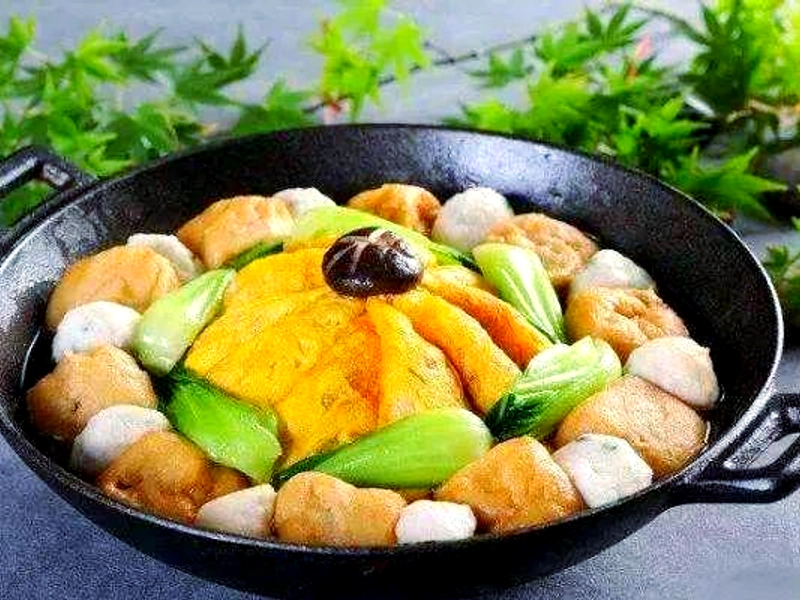 Hu Shi Hotpot with assorted meats, vegetables, tofu, and mushrooms in a rich broth