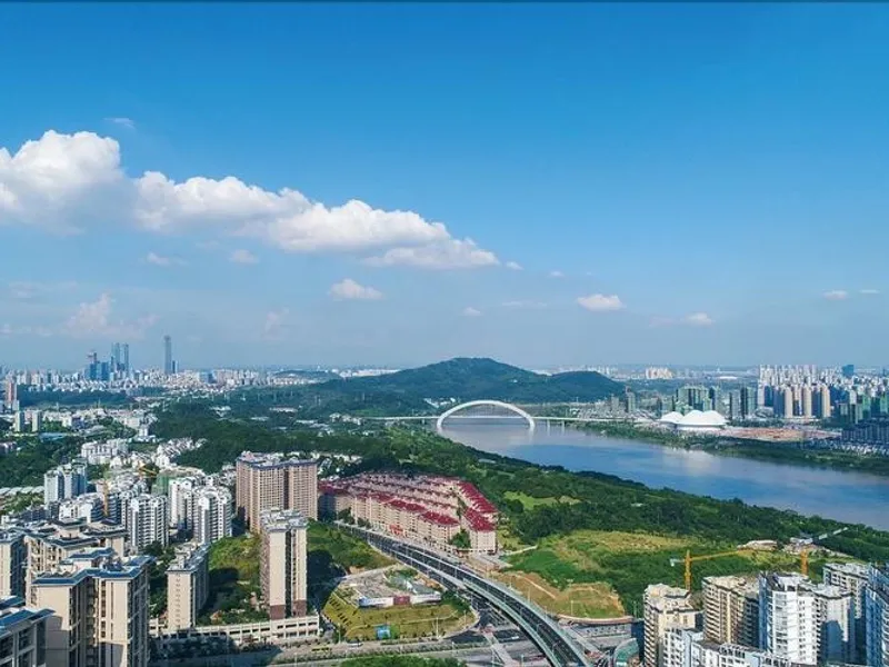 Panoramic view of Nanning showcasing Qingshui Mountain, Longxiang Tower, and Nanhu Lake reflecting city greenery and modern architecture