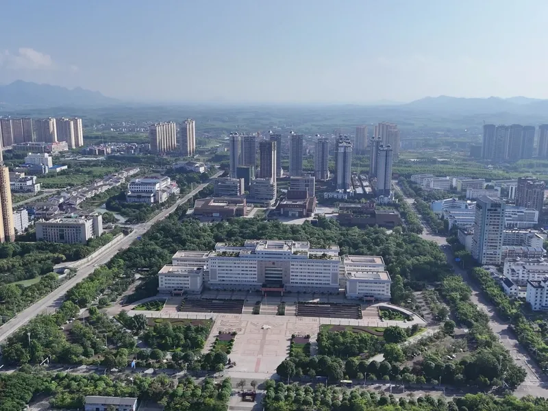 Laibin city along the Hongshui River with surrounding green hills and karst landscapes, illustrating harmony of industry and nature