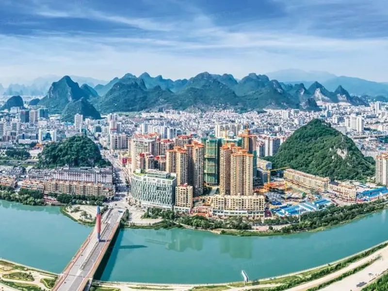 Hezhou mountainous landscape with temples and ancient towns, showcasing Lingnan cultural heritage and verdant scenery