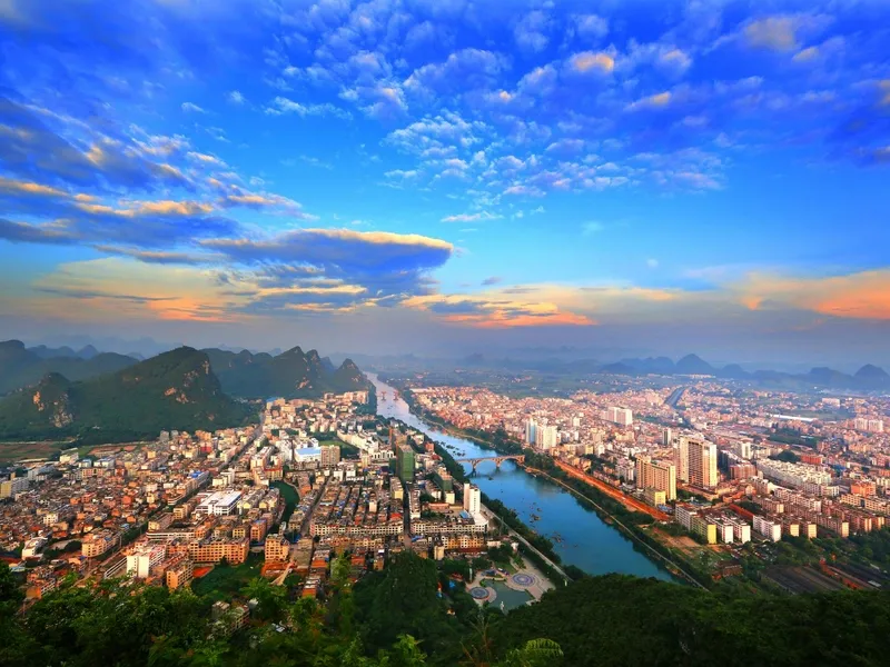 Hechi mountainous terrain with rivers and forests, highlighting Zhuang, Yao, and Miao ethnic culture and revolutionary heritage