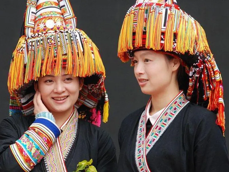 Yao villagers performing traditional dance wearing bright embroidered clothing and silver ornaments