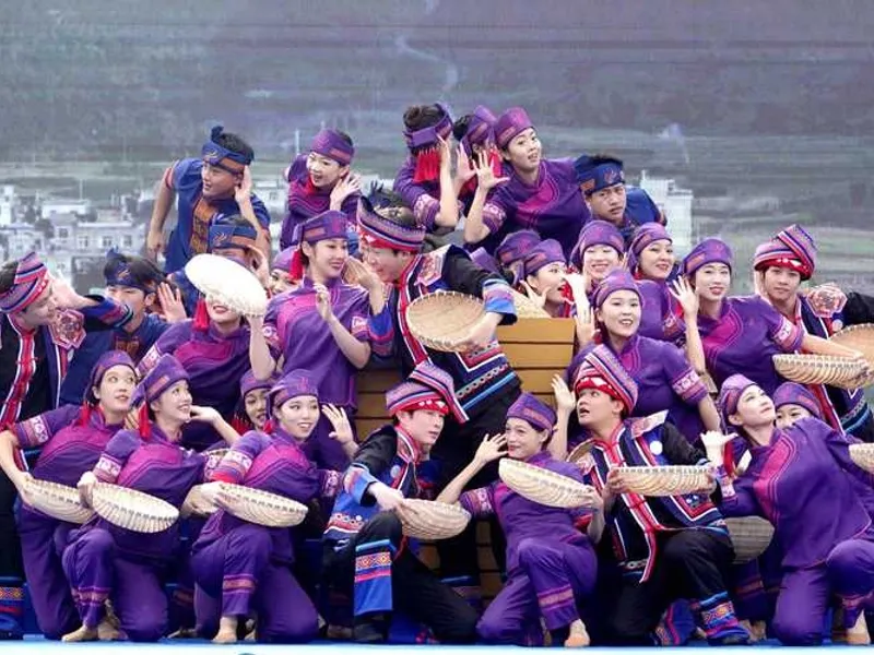 Mulao villagers celebrating the Yifan Festival, offering rice at ancestral altars with singing echoing through the valley