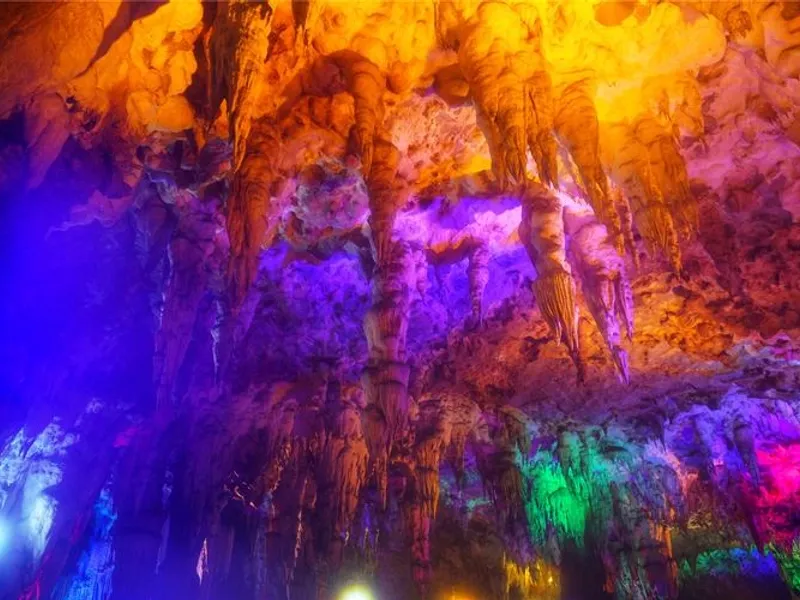 Debao karst caves with stalactites, stalagmites, and underground rivers illuminated by soft light