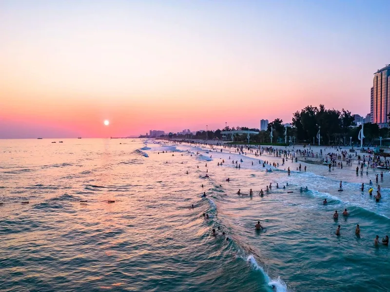 Detian Waterfall roaring with rainbow and Beihai Silver Beach under summer sun