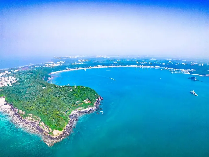 Weizhou Island volcanic lava coast with black rocks, azure waters, mangroves, and tropical vegetation