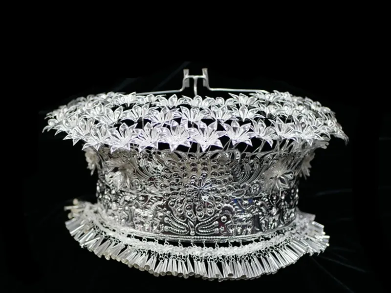 Yao women wearing silver ornaments with intricate carvings during a traditional festival