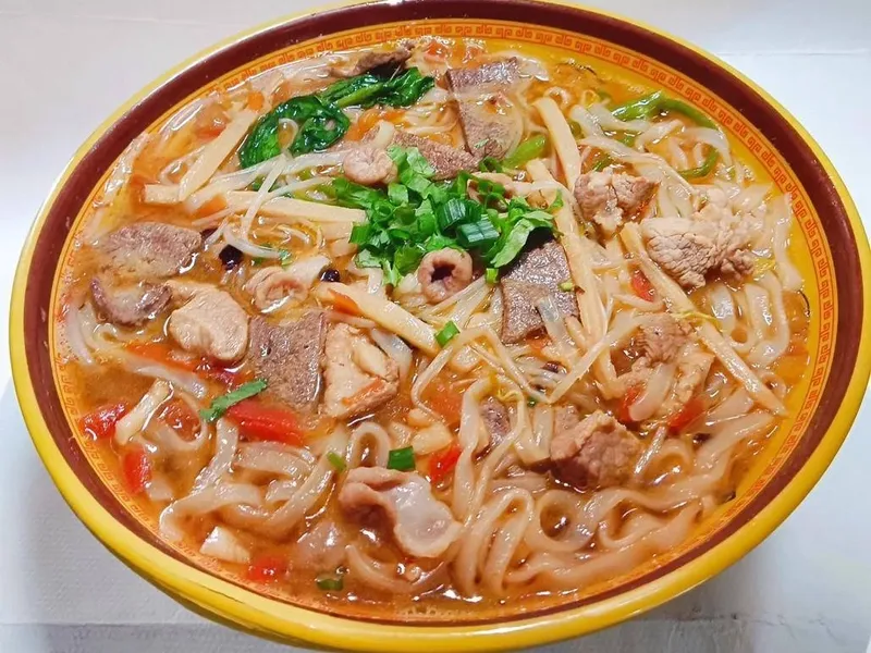 Nanning Laoyou rice noodles with pickled vegetables, peanuts, and scallions in a savory broth