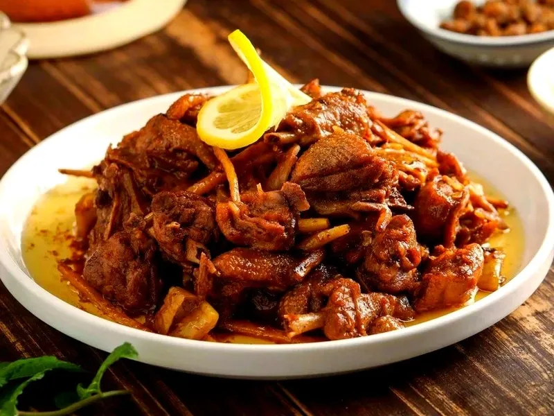 Lemon duck dish with tender duck meat, lemon slices, and aromatic spices
