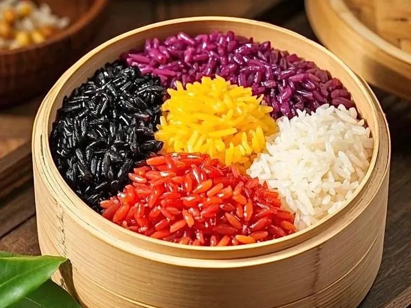 Five-color glutinous rice with red, yellow, purple, white, and green layers served on a festive plate