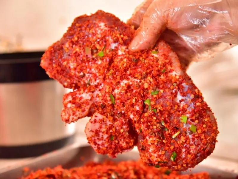 Sour fish and meat dish with tender fish, pork, and tangy fermented sauce