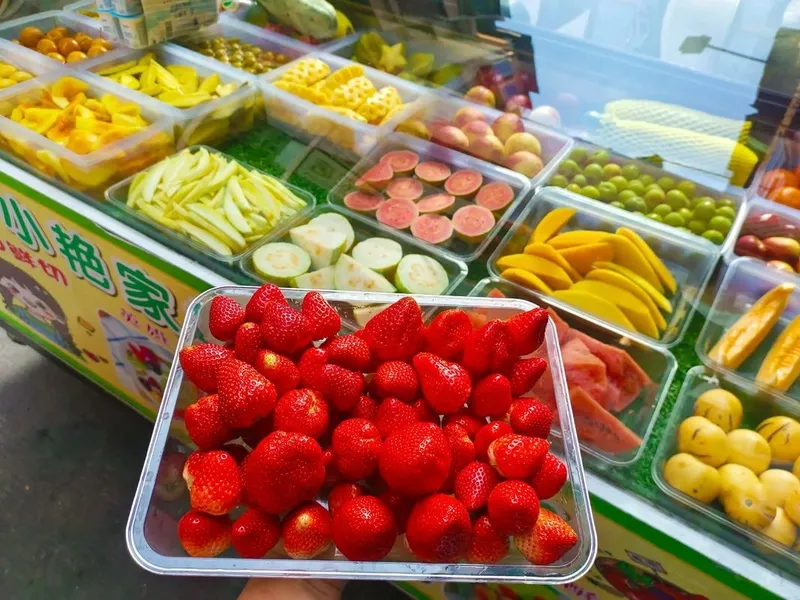 Fresh fruits being prepared into Guangxi Suan Ye, sweet-and-sour traditional snack