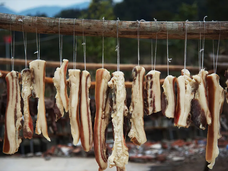 A scene showing farmers curing meat and making pickles, symbolizing the final agricultural 'storage' activities after the autumn harvest at Lidong.