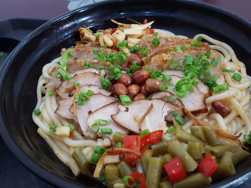 Guilin Rice Noodles bowl with toppings and condiments
