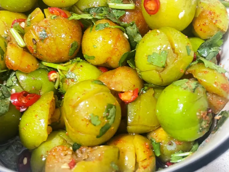 Colorful pickled fruits and vegetables sold by street vendors