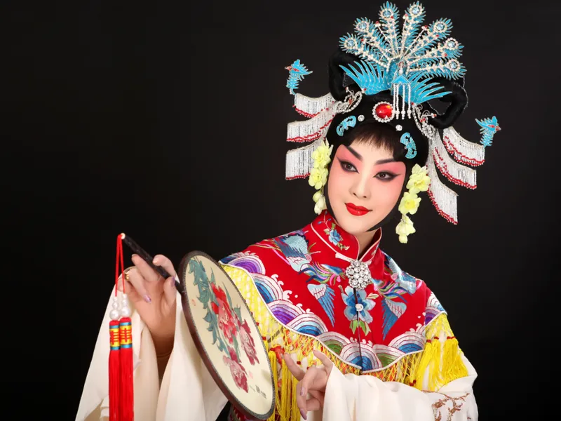 Traditional Chinese Peking Opera performers wearing elaborate masks and costumes