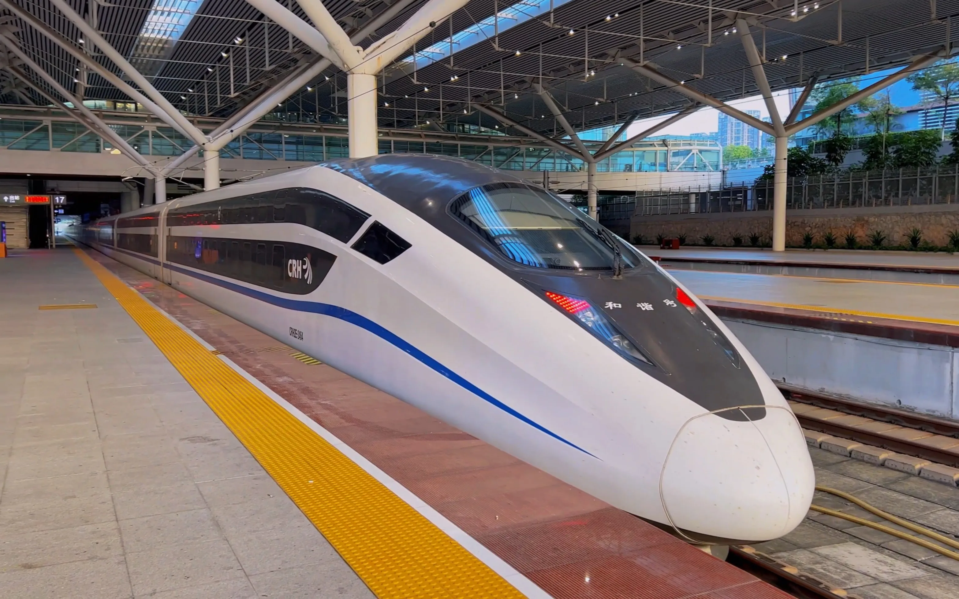 China’s high-speed bullet train passing through modern city landscape, representing technological progress and rapid travel.
