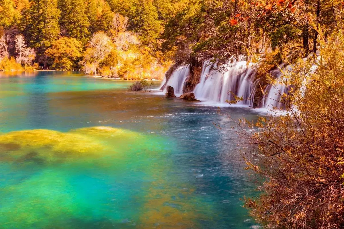 Jiuzhaigou in November, golden forests surrounding turquoise lakes