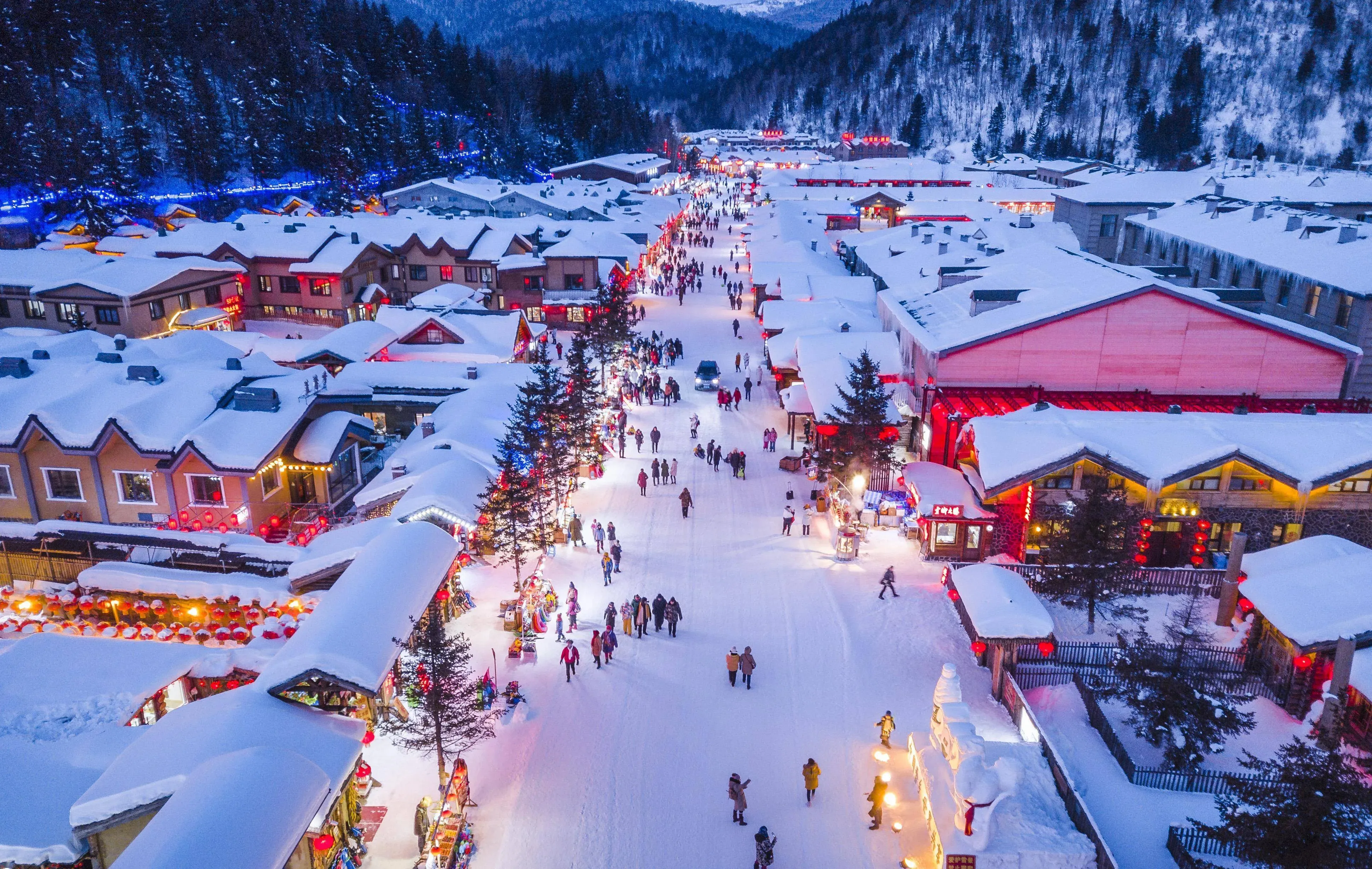 Xuexiang Snow Village in late November, snow-covered rooftops and red lanterns