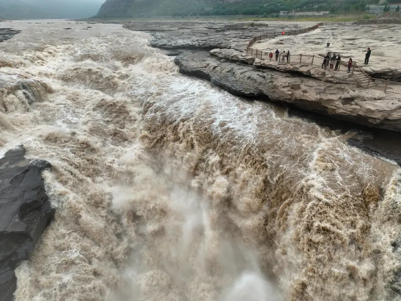 The Yellow River showing its yellow loess waters, demonstrating the soil that gives it its name and creates both fertile plains and flooding challenges.