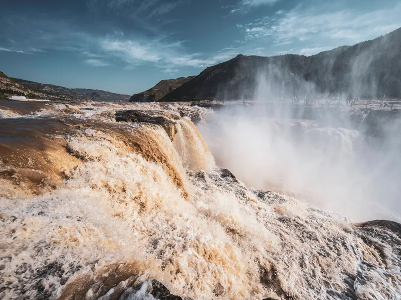 The Yellow River (Huang He) flowing through China, showing its yellow loess waters, fertile plains, and surrounding landscapes, symbolizing Chinese civilization, history, and cultural heritage.