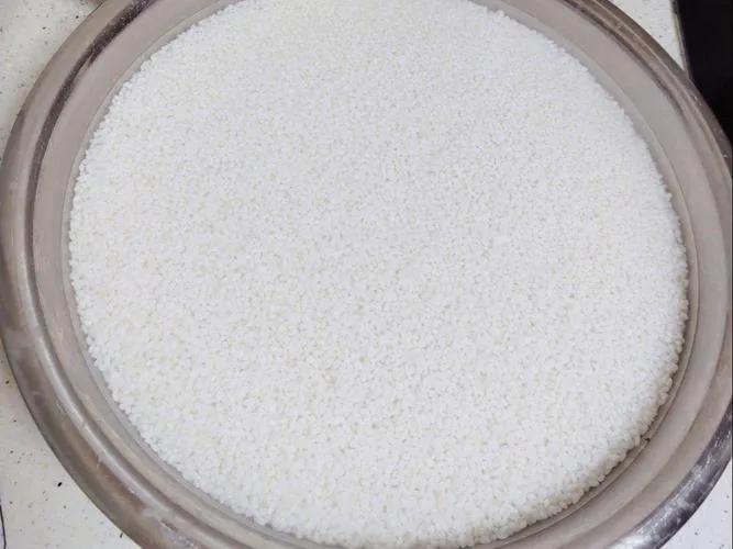 Sticky rice grains being rinsed in water to remove excess starch, an essential step in preparing sticky rice for cooking