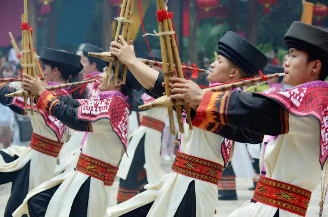 Miao musicians playing the Lusheng (bamboo reed instrument) during a festival