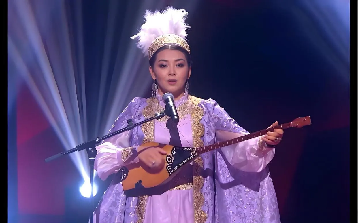 Uyghur musician playing the Dutar (two-stringed lute) in Xinjiang
