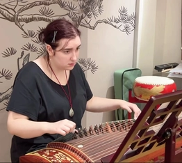 Students learning to play the guzheng, a traditional Chinese instrument, during a study tour with RPL School