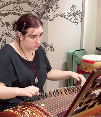 Student playing Guzheng (Chinese Zither)